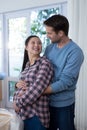 Man touching womans pregnant belly at new house Royalty Free Stock Photo