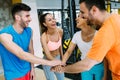 Smiling men and women doing high five in gym Royalty Free Stock Photo