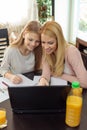 Smiling woman helping her teenage daughter with homework Royalty Free Stock Photo