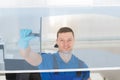 Worker Cleaning Glass Window With Squeegee Royalty Free Stock Photo