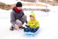 Smiling middle age Asian Father and cute smiling little 2-3 years old toddler boy child playing happily in snow Royalty Free Stock Photo