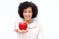 Smiling middle age woman holding red apple against white background Royalty Free Stock Photo