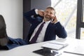 Smiling Middle Aged Businessman Relaxing With Cellphone At Workplace In Office Royalty Free Stock Photo