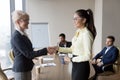 Smiling businesswoman handshake Asian employee greeting with ach Royalty Free Stock Photo