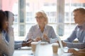 Smiling middle-aged businesswoman hold company office briefing