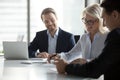 Smiling middle aged businesswoman signing paper contract at group meeting Royalty Free Stock Photo