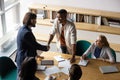 Smiling diverse colleagues handshake getting acquainted at meeting Royalty Free Stock Photo