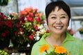 Smiling middle aged chinese woman holding flowers