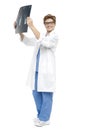 Smiling middle aged doctor holding up x-ray sheet Royalty Free Stock Photo