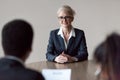 Smiling middle-aged female job applicant making first impression at interview