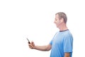 Smiling Middle aged man using  smartphone texting while listening to music over white background . Man listening to music or Royalty Free Stock Photo