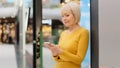 Smiling middle aged mature caucasian woman holding phone looking at smartphone screen sending message checking email Royalty Free Stock Photo