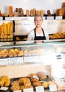 Saleswoman working at counter of bakery