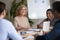 Smiling middle aged team leader speaking at corporate meeting Royalty Free Stock Photo