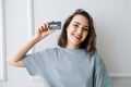 Smiling Middle-Aged Woman Displaying Credit Card in Studio Close-up. Cheerful Mature Woman Showing Credit Card in Studio Royalty Free Stock Photo