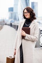 Smiling middle-aged woman with glasses on his face, with books and wooden case in their hands Royalty Free Stock Photo