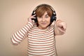 Woman with headphones pointing her index finger at the camera Royalty Free Stock Photo