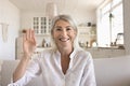 Middle aged woman greets friend on video call