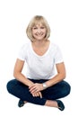 Smiling middle aged woman sitting on the floor Royalty Free Stock Photo