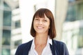 Smiling middle aged woman standing outside Royalty Free Stock Photo