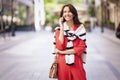 Attractive woman using smartphone at sidewalking in the city Royalty Free Stock Photo