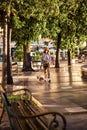 Smiling middle aged woman walking with her cute dog on the street Royalty Free Stock Photo