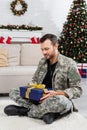 smiling military man sitting on floor