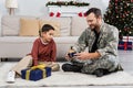 smiling military man sitting on floor