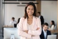 Smiling millennial african american corporate employee executive looking at camera