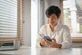 Smiling Asian man using mobile banking application to transfer money. mobile banking Royalty Free Stock Photo