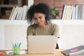 Smiling millennial black female working at laptop Royalty Free Stock Photo