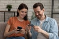 Smiling millennial caucasian couple shopping in mobile application. Royalty Free Stock Photo