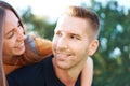 Smiling millennial couple in love having fun outdoors - looking into each other`s eyes - Relationship outdoor concept Royalty Free Stock Photo