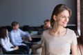 Smiling millennial female leader looking away dreaming of future Royalty Free Stock Photo