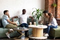 Smiling diverse young people get acquainted in cafe Royalty Free Stock Photo