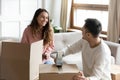 Smiling young couple packing boxes with adhesive tape Royalty Free Stock Photo