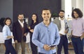 Portrait of happy business team leader standing in office with group of employees Royalty Free Stock Photo