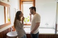 Smiling millennial married couple cleaning teeth at modern designed bathroom Royalty Free Stock Photo