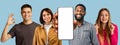 Smiling millennial multiracial people show smartphone with empty screen, make success and ok gesture