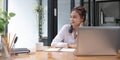 Smiling millennial woman talking on the phone at home, happy young girl holds cellphone making answering call Royalty Free Stock Photo