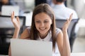 Smiling female employee read good news at laptop in office