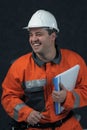 Smiling mine worker with file Royalty Free Stock Photo