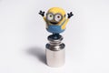 Happy despicable minion toy staying on the little scales weight