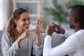 Smiling mixed ethnicity couple talking with sign finger hand language Royalty Free Stock Photo