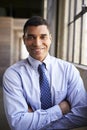 Smiling mixed race businessman with arms crossed, portrait Royalty Free Stock Photo