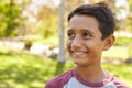 Smiling mixed race Caucasian Asian boy in park looking away