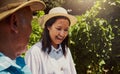 Smiling mixed race couple bonding on vineyard. Happy hispanic husband and wife laughing and enjoying day on a farm after