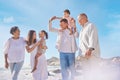A smiling mixed race three generation family with little girls walking together on a beach. Adorable little kids bonding Royalty Free Stock Photo