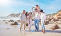 A smiling mixed race three generation family with little girls walking together on a beach. Adorable little kids bonding Royalty Free Stock Photo