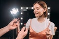 Smiling model taking lipstick from makeup